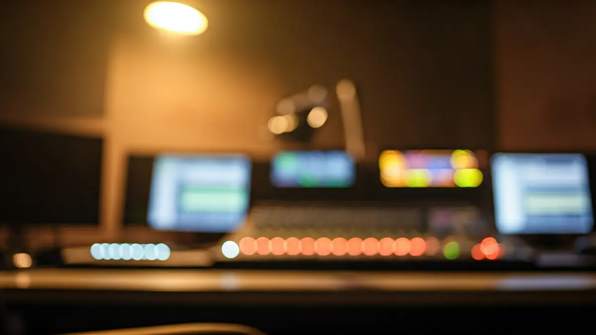 Generic image of a radio studio with a microphone and a mixing board.