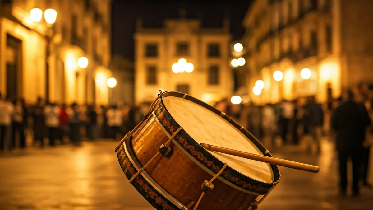 Image of a Moorish and Christian festival drum, with people and historic buildings in the background.