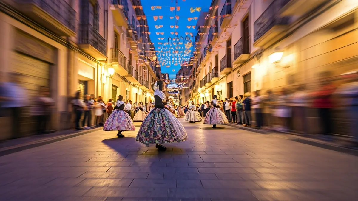 Image of a traditional Valencian 'dansà' with blurred figures and festive decorations.
