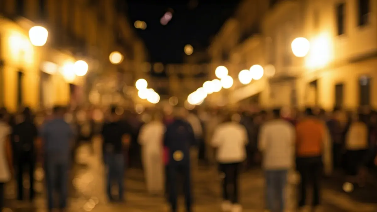 Generic image of a festive procession in a Mediterranean square, with confetti and streetlights.