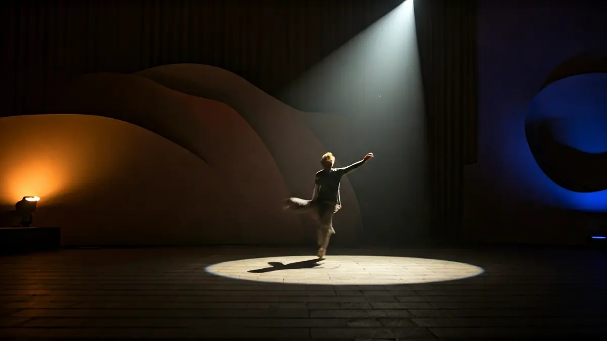 Generic image of a dance stage with a dancer in motion and theatrical lighting.