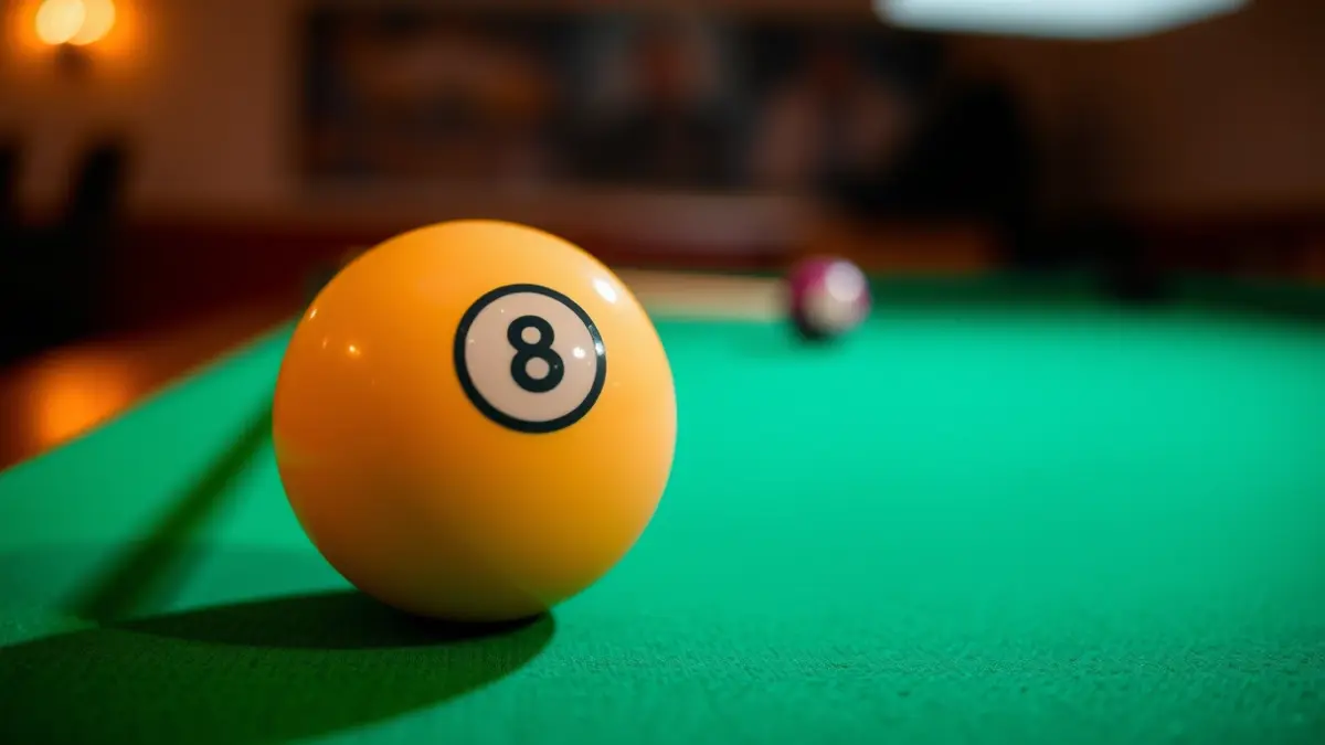 Imatge genèrica d'una bola de billar sobre una taula verda, amb un tac desenfocat al fons.