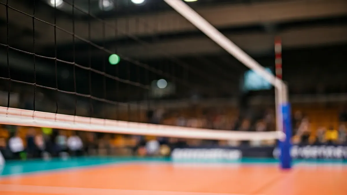 Generic image of a volleyball net on an indoor court.