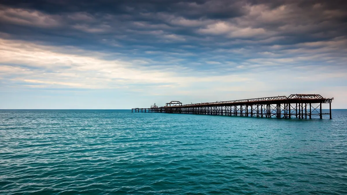 Image of the Pantalán of Port de Sagunt, with its deteriorated metal structure extending into the sea.