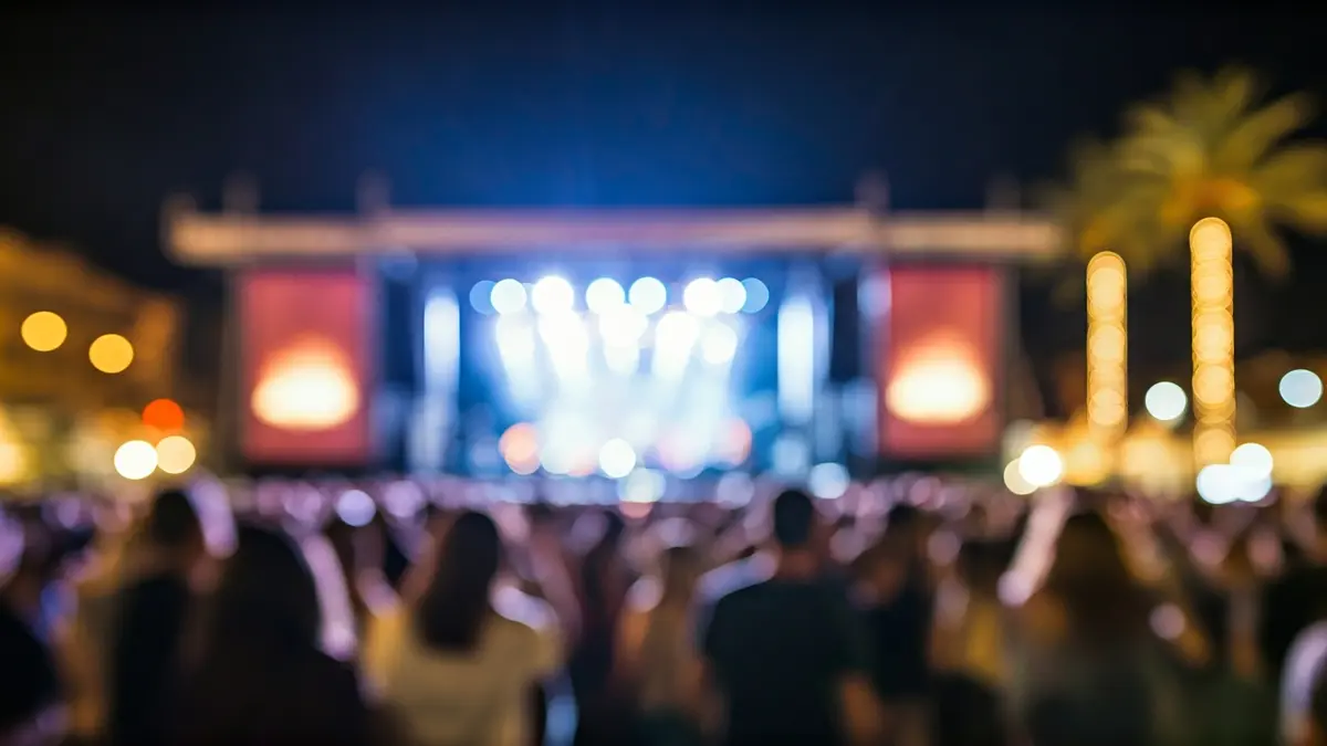 Generic image of a music festival stage with lights and a crowd.