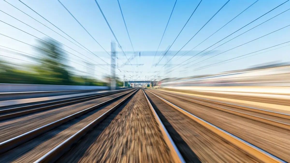 Generic image of train tracks with a green signal, symbolizing normal service.