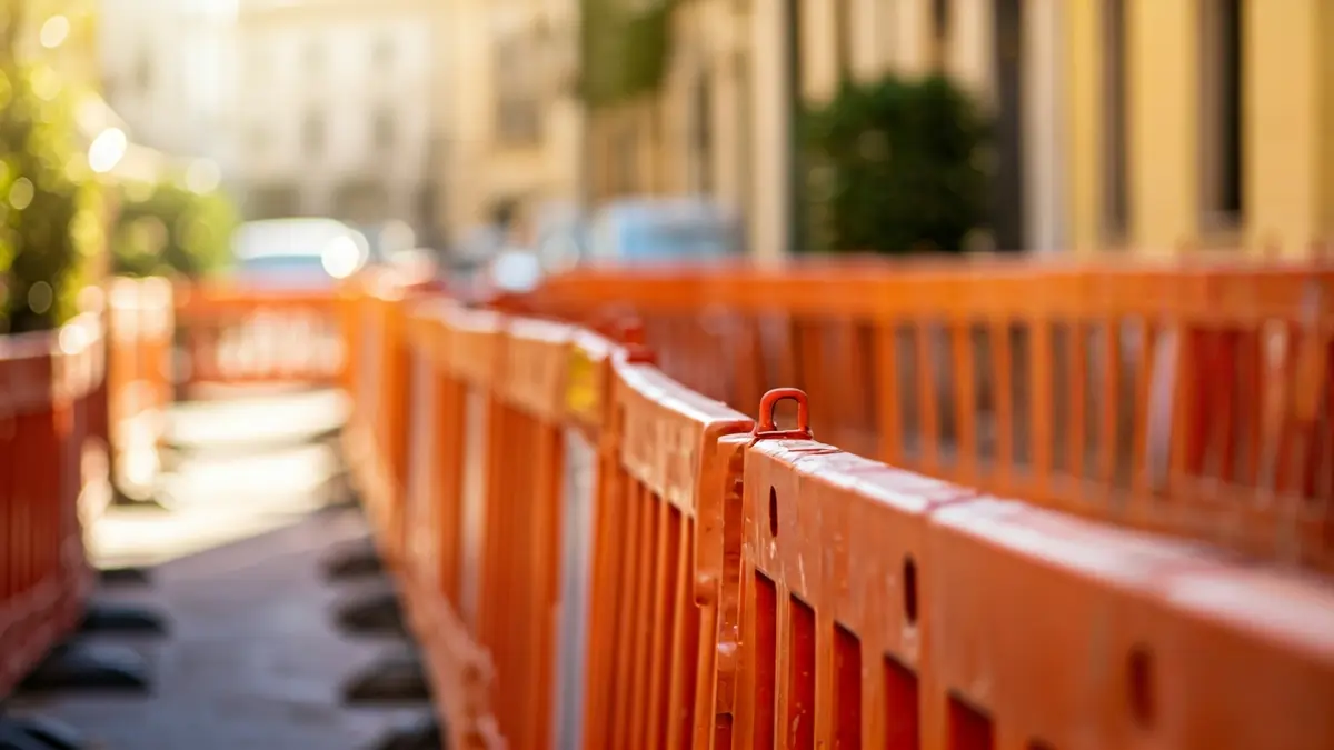 Image of stalled planter construction with orange safety barriers.