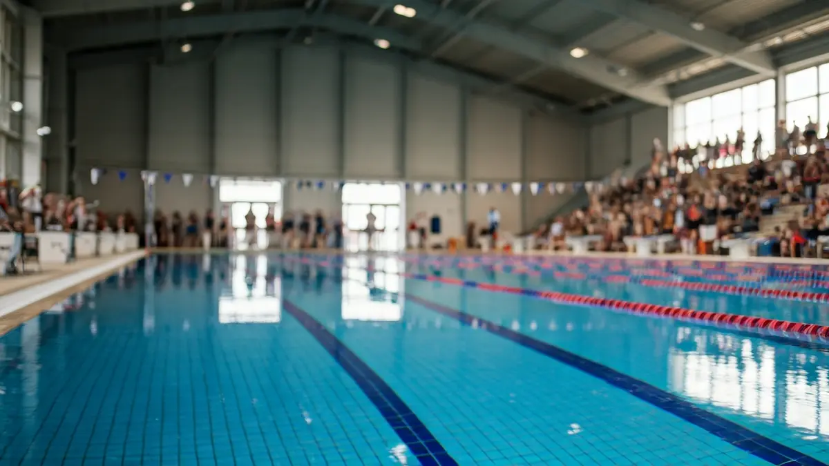 Generic image of an indoor swimming pool with lanes and starting blocks.