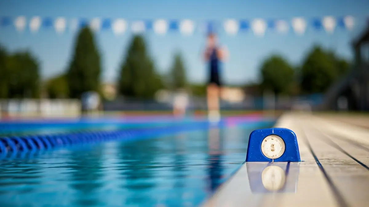 Generic image of a swimming pool with a running track in the background, symbolizing a multi-sport event.