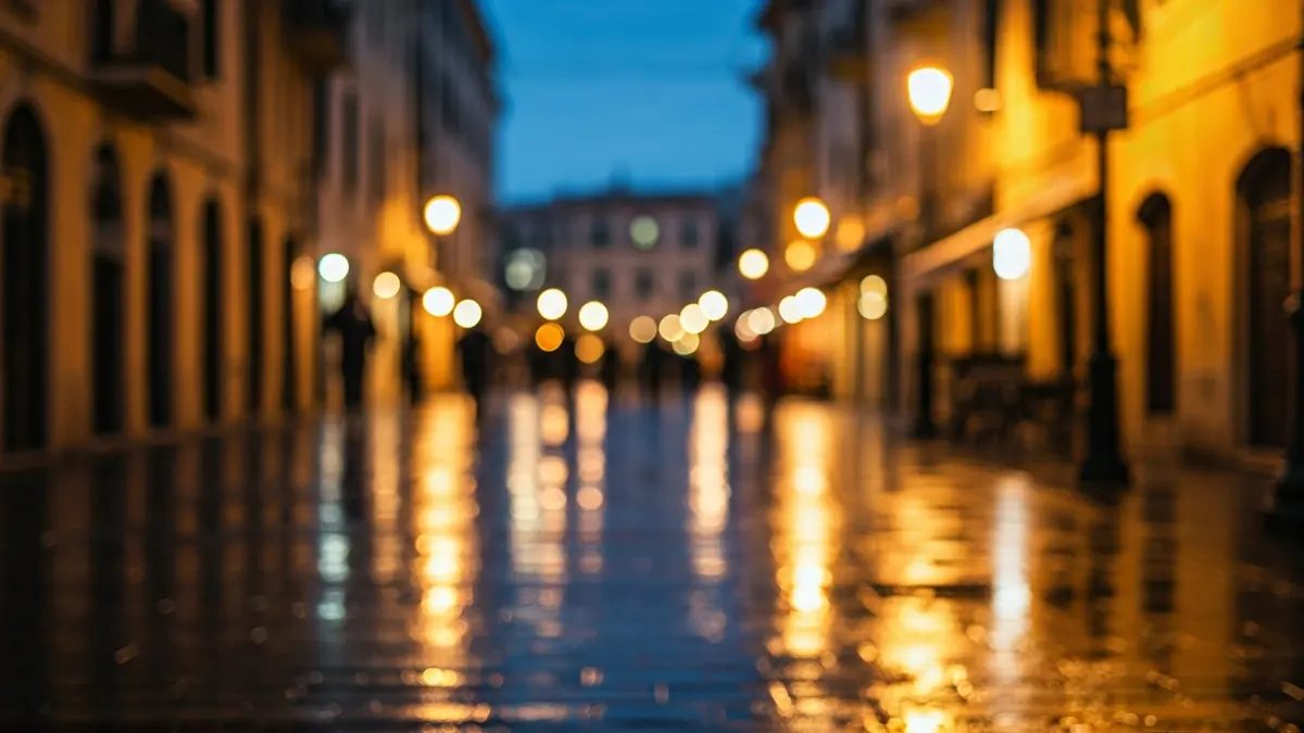 Generic image of a Mediterranean city with rain, blurred lights reflecting on wet asphalt.