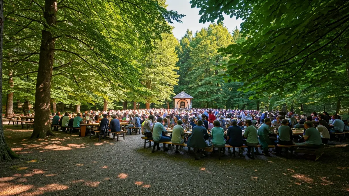 Imatge d'una multitud de persones en un parc natural gaudint d'un esmorzar tradicional, amb una ermita al fons, durant una jornada festiva.