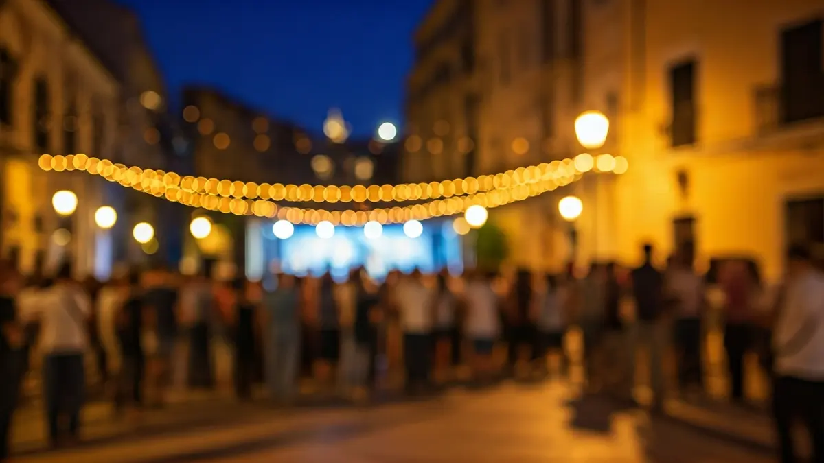 Image of a flamenco music festival in a Mediterranean square with people and lights.