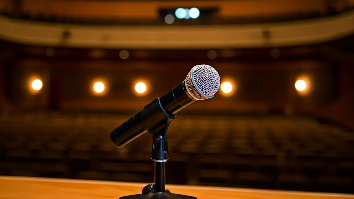 Generic image of a microphone on a podium in an auditorium, symbolizing a closing ceremony or conference.