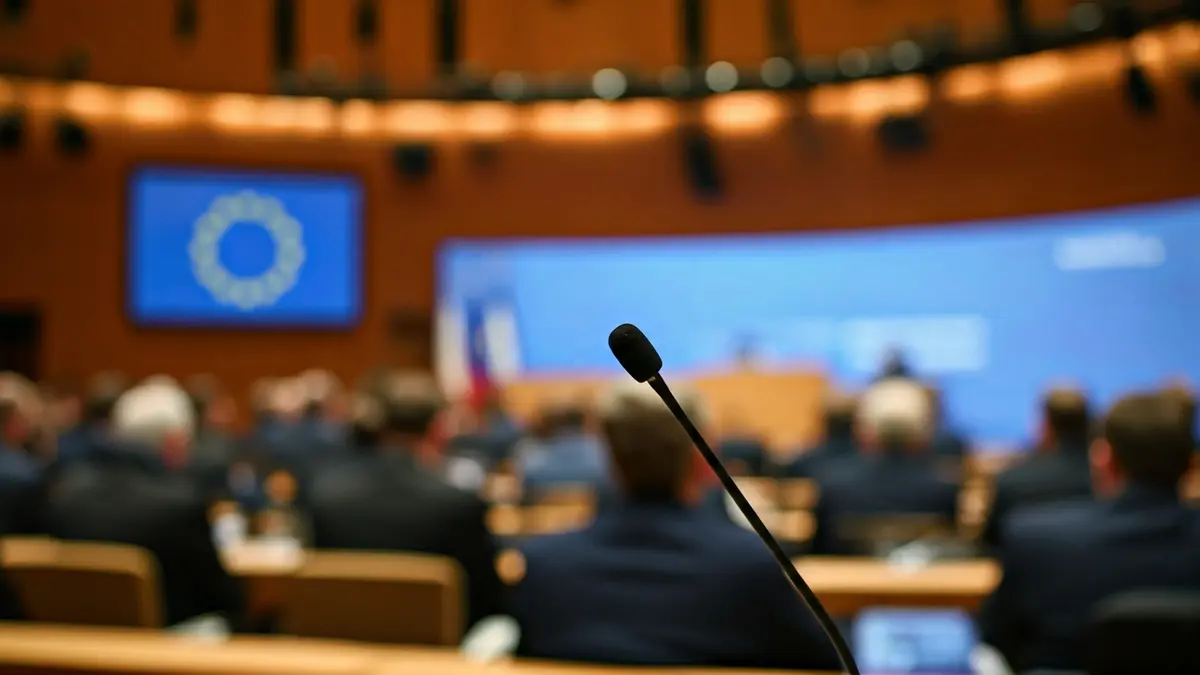 Generic image of a forum or conference with a podium and microphone.