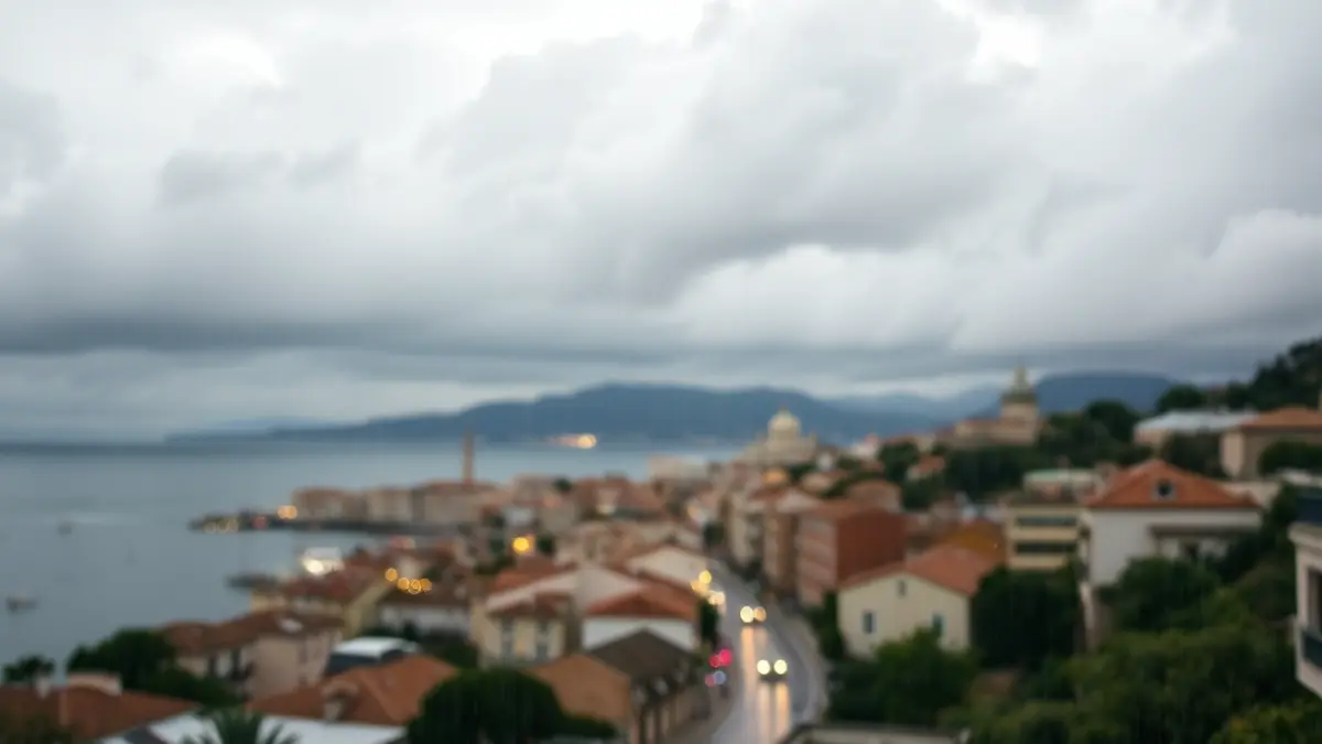 Generic image of an overcast sky with high clouds over a Mediterranean coastal town, with light rain and wet streets.