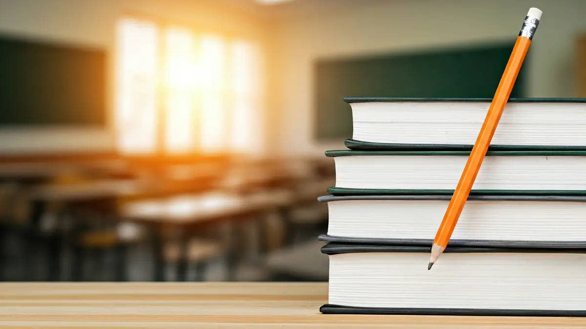 Generic image of school books and supplies on a desk.