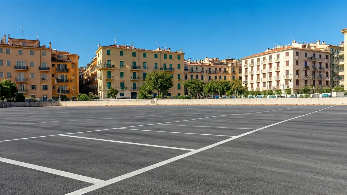 Generic image of an empty parking lot with Mediterranean buildings in the background.