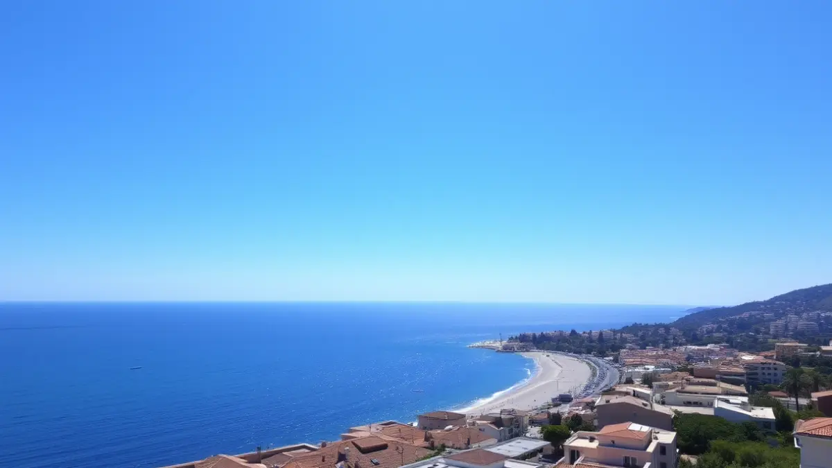 Generic image of a clear sky over a Mediterranean coastal city, with a sandy beach and calm sea.