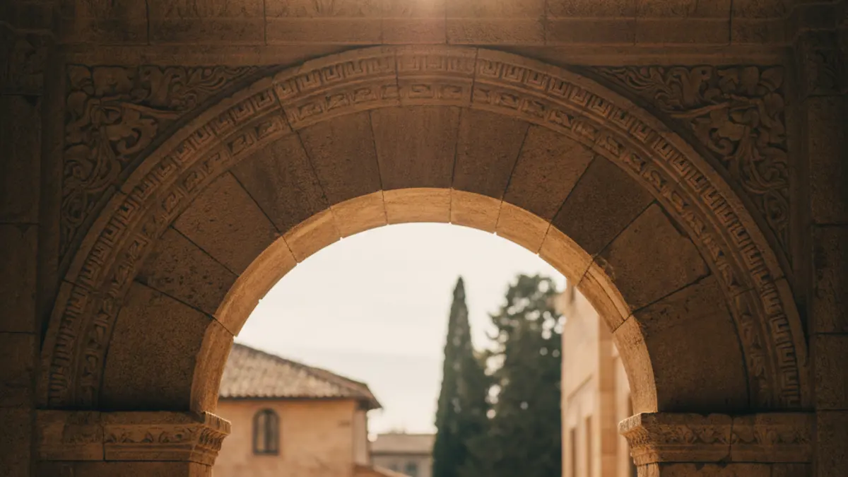 Image of an ancient stone archway in a historic building, with warm light filtering through, suggesting a rich cultural heritage.