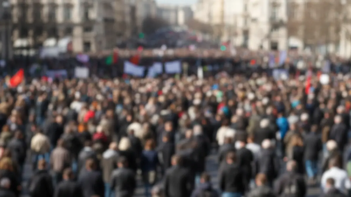 Generic image of a picket sign at an educational protest, with blurred people in the background.