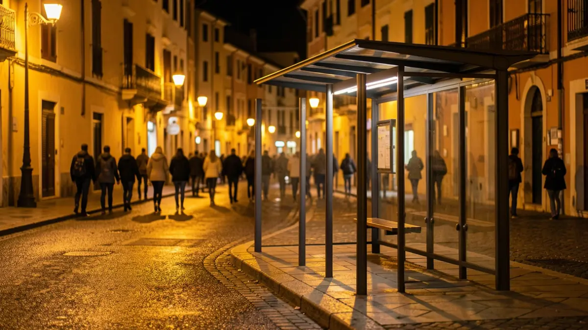 Generic image of a nighttime bus stop in a Mediterranean setting.