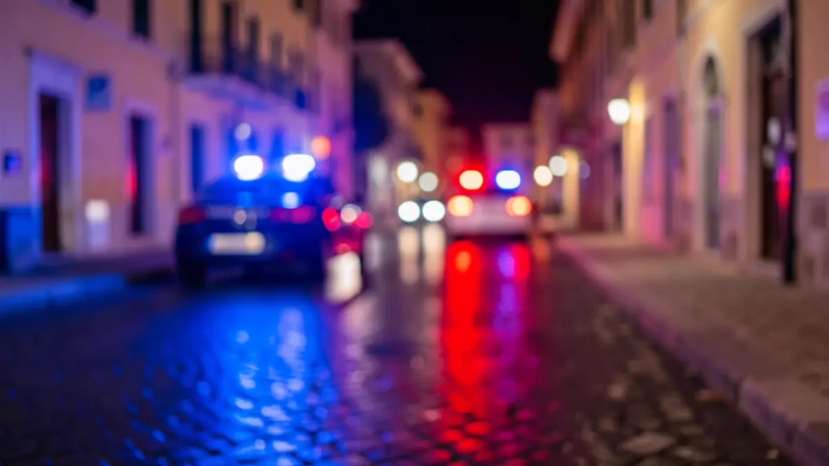 Generic image of police emergency lights reflecting on wet asphalt.
